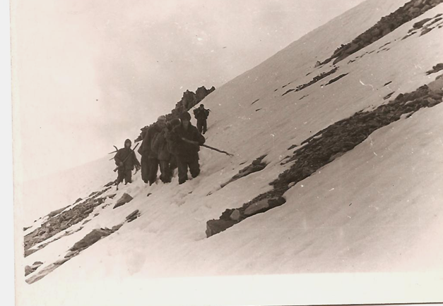 Начало передвижение группы по горному снежному склону к вершине перевала